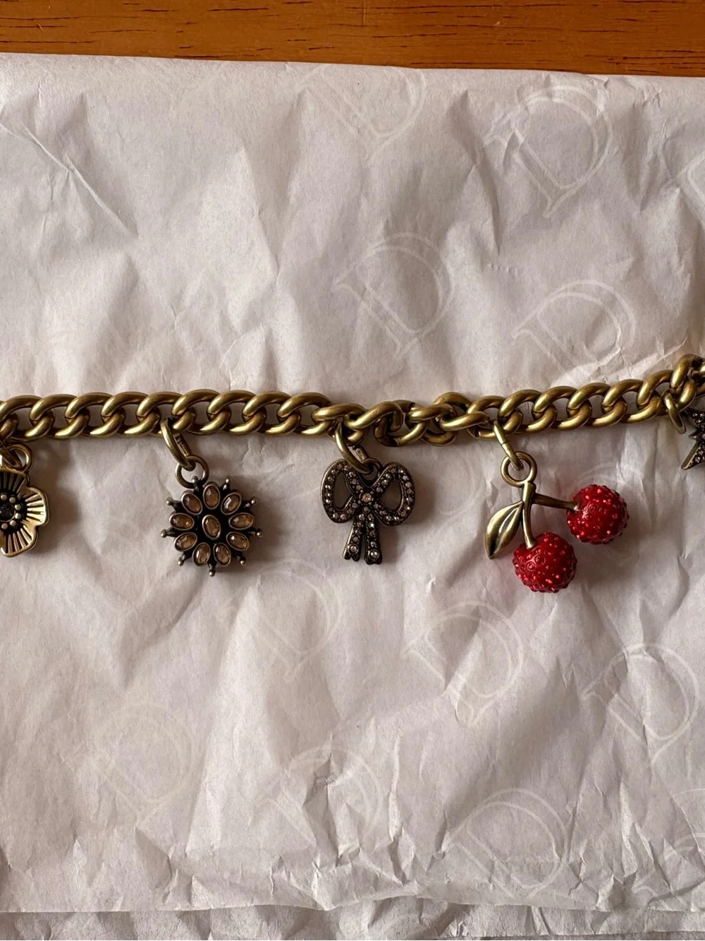 Coach Antique Brass Charm Bracelet with Red Cherry Accents and Floral Charms